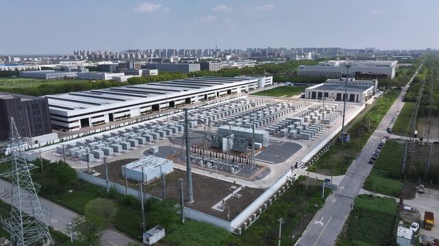 Aerial view of large energy storage power station with container units and grid infrastructure
