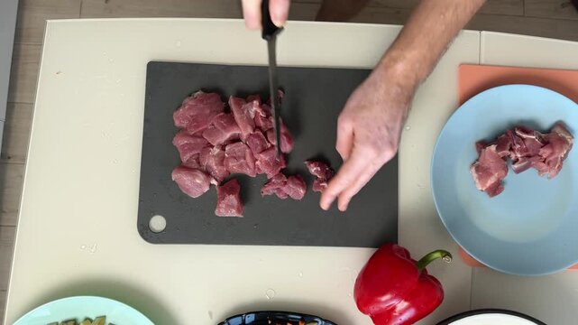 Dicing Raw Pork Into Small Cubes Neat Rows Of Trimmed Meat Hands Working Quickly Prep For Stirfry Or Stew