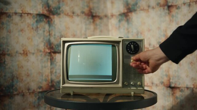 In a warm, retro-themed room, a vintage TV flickers with static and grainy visuals, setting a spooky, nostalgic mood. Perfect for the Halloween season and creative projects