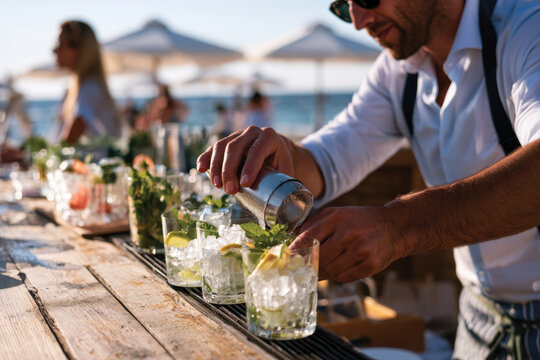 An expert bartender meticulously prepares mojitos, showcasing fresh mint and lime, in a lively beach bar setting filled with joyful patrons seeking refreshing drinks.