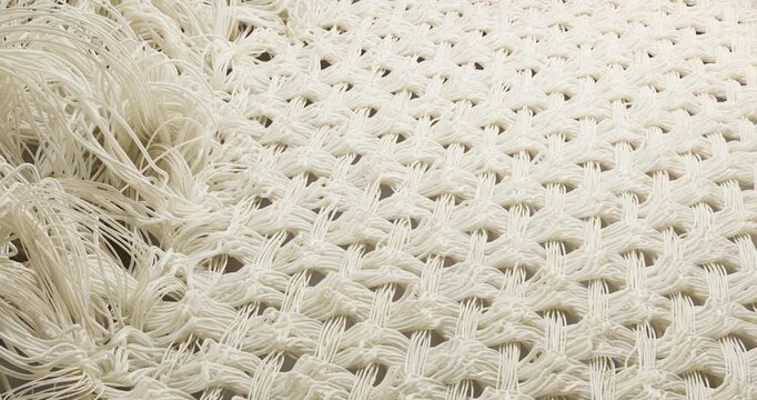 3D animation macro photography of the restoration of milky-white textile fibers on a light background. The chaotic, tangled and fluffy mass of damaged threads turns into an orderly, smooth and tightly