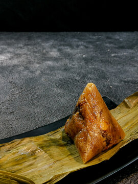 Bacang is a traditional Chinese food that is usually filled with soy sauce pork or chicken, salted egg, and sometimes mushrooms or peanuts.