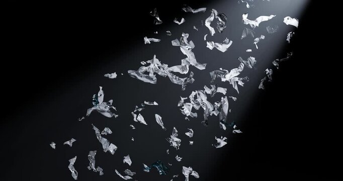 3D close-up animation shows heterogeneous microplastic particles moving against a deep black background. A sharp, directional beam of light passes diagonally through the center of the frame (the effec