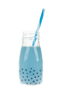 Blue bubble tea in glass bottle with straw, trendy Asian boba drink with black tapioca pearls, white background