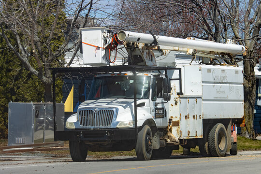 Quebec, Canada, 24 April 2026 : S. CARON'S Tree Services International utility truck with a bucket lift and wood chipper.