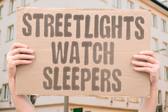 "Streetlights Watch Sleepers" Visible hardship blends into nightly city life. POVERTY. STREETS. NIGHT. URBAN. SURVIVAL.