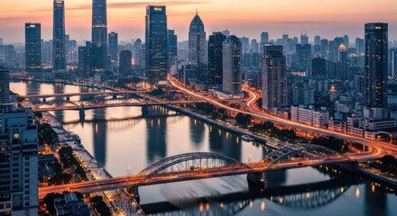 Fototapeta premium Cityscape at dusk modern architecture and illuminated bridges over a river