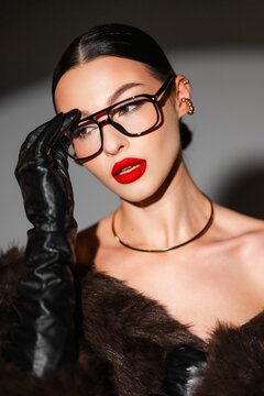 An Elegant Woman Exudes Vintage Appeal Accented By Rich Garments And Impressive Lighting Designs