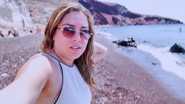 Influencer vlogging at red beach santorini, greece