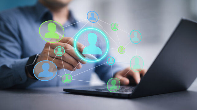 Customer profiling interface with audience analytics and connected CRM user network. Business professional analyzing customer profiles on laptop computer