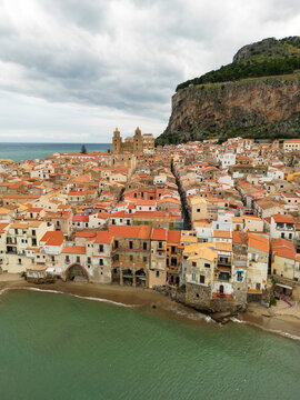 Aerial view of Cefalu town with a gathering storm in the background. Cefal&ugrave; is a coastal town in northern Sicily, Italy. Its Duomo, Cefal&ugrave; Cathedral, is a world heritage site