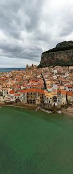 Aerial view of Cefalu town with a gathering storm in the background. Cefal&ugrave; is a coastal town in northern Sicily, Italy. Its Duomo, Cefal&ugrave; Cathedral, is a world heritage site