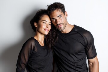 Obraz premium Portrait of a content latino couple in their 30s showing off a lightweight base layer isolated in white background