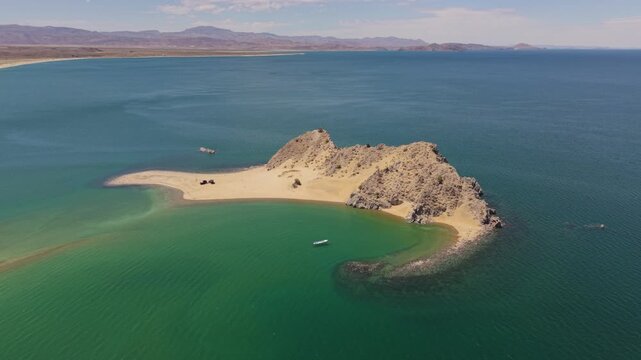 Discover camping in Punta Final, Gonzaga Bay, Baja California, Mexico where an SUV with a teardrop trailer sits on a remote island beach.