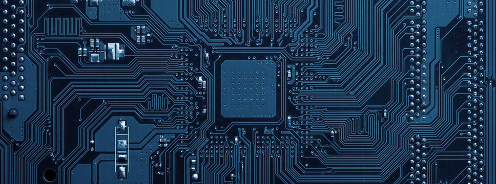 Close-up view of a blue circuit board featuring intricate patterns of electronic connections and components. Represents technology and innovation.