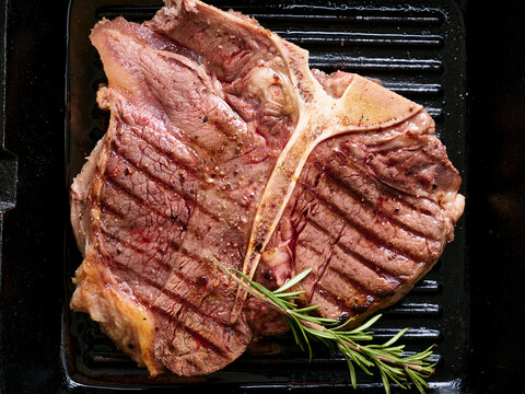 Grilled t-bone steak cooked on a hot grill for a delicious meal enjoyed at a summer barbecue