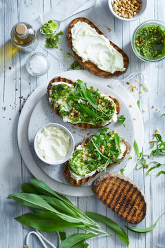 Wild Garlic Pesto Toast with Cream Cheese and Pine Nuts &ndash; Spring Herb Food Photography