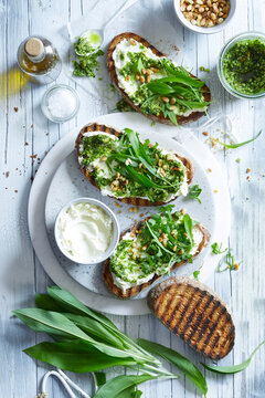 Wild Garlic Pesto Toast with Cream Cheese and Pine Nuts &ndash; Spring Herb Food Photography