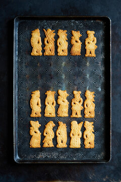 Traditional Speculoos Cookies with Festive Figures on Dark Baking Tray &ndash; Top View