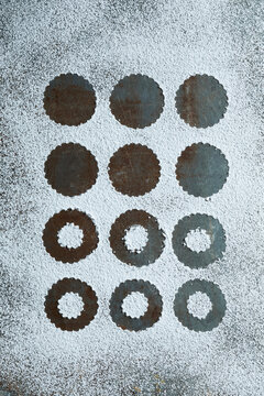 Top view of Linzer cookies with red jam and powdered sugar on a rustic surface