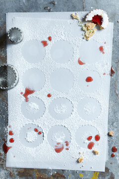 Top view of Linzer cookies with red jam and powdered sugar on a rustic surface