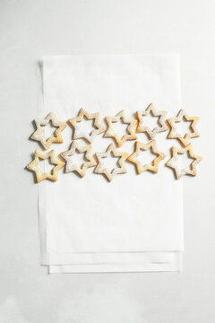 Star-shaped Linzer cookie tops with powdered sugar on a clean white background.