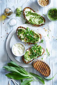 Wild Garlic Pesto Toast with Cream Cheese and Pine Nuts &ndash; Spring Herb Food Photography