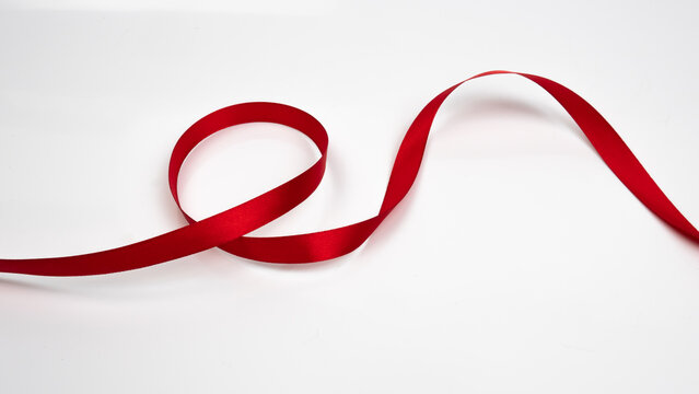 Abstract shape color red ribbon isolated on white background.  top view