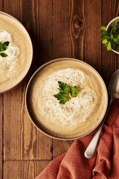 White Beetroot Soup with parsley on wooden table