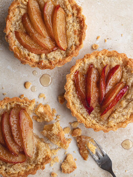 Plum Frangipane Tarts on a stone surface