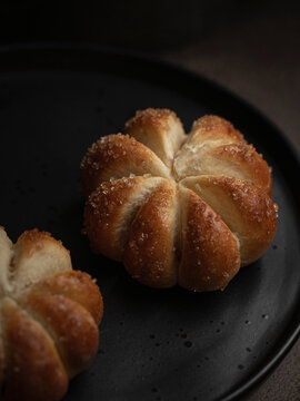Home baked pumpkin shaped sweet buns on a plate
