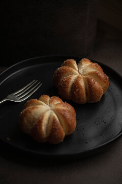 Home baked pumpkin shaped sweet buns on a plate