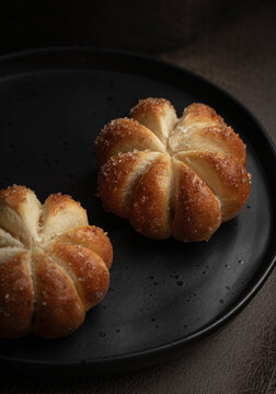Home baked pumpkin shaped sweet buns on a plate