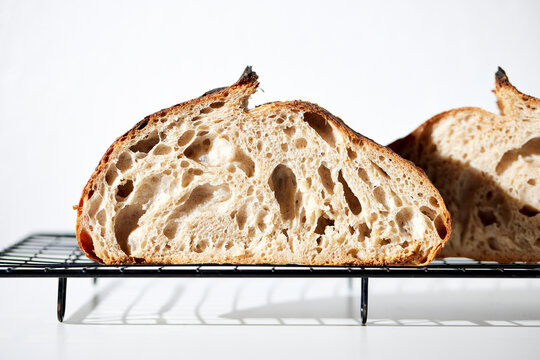 Sourdough Loaf Sliced in Half on a Light Background