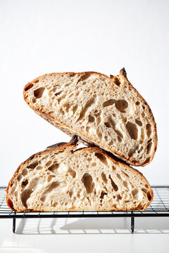 Sourdough Loaf Sliced in Half on a Light Background