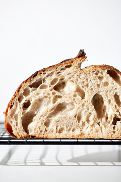 Sourdough Loaf Sliced in Half on a Light Background