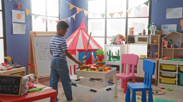 African american boy stacking colorful blocks at a play table inside a building; curiosity learning play.