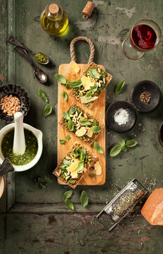 Pesto crisp bread garnished with pine nuts and parmesan cheese