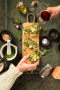 Pesto crisp bread garnished with pine nuts and parmesan cheese