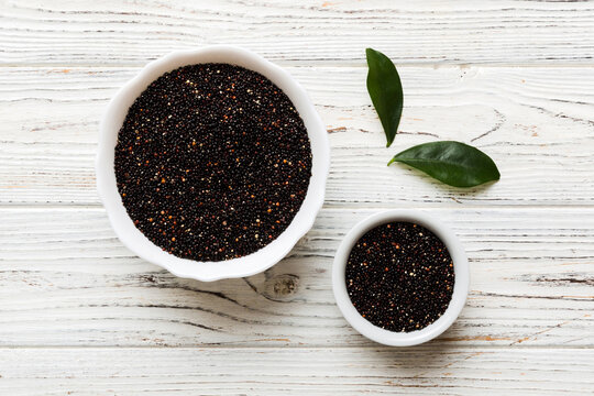 quinoa seeds in bowl on colored background. Healthy kinwa in small bowl. Healthy superfood