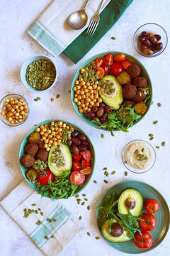 Super Healthy Mediterranean Bowl for Gut Health. Plant-based, High-Fiber, Longevity Diet, with Rocket Leaves, Falafel, Roasted Chickpeas, Kalamata Olives, Truss Tomatoes and Avocado.