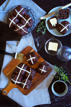 Chocolate Hot Cross Buns. Traditional Easter celebration yeast buns flatlay on dark marble table background.