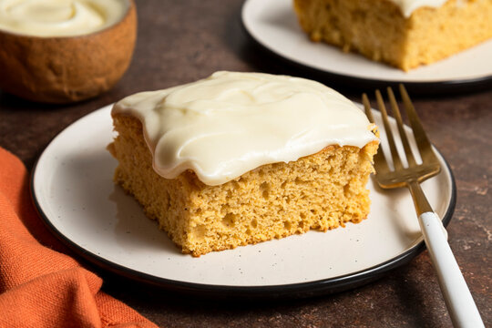 Slice of sheet cake with cream cheese frosting