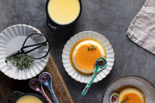 Thyme infused custard served in delicate bowls with aromatic syrup