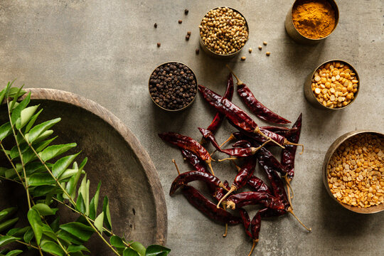 Rasam podi ingredients arranged with spices, lentils, and curry leaves.