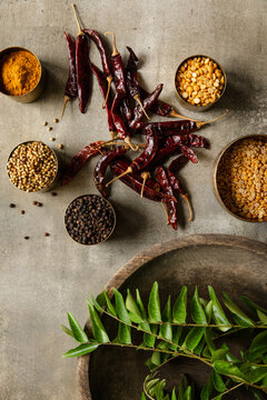 Rasam podi ingredients arranged with spices, lentils, and curry leaves.