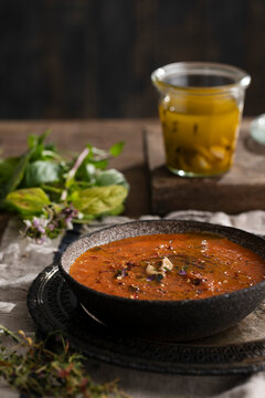 Roasted tomato soup topped with garlic olive oil and fresh herbs