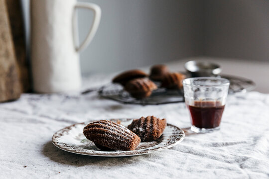 Chocolate madeleines on vintage plate with espresso