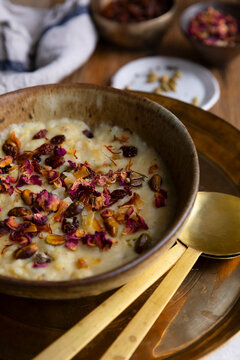 Traditional moong dal payasam garnished with nuts, raisins, and rose petals.