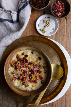Traditional moong dal payasam garnished with nuts, raisins, and rose petals.
